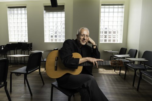 Petar Kodzas with guitar in classrroom Petar Kodzas with guitar in classrroom photo