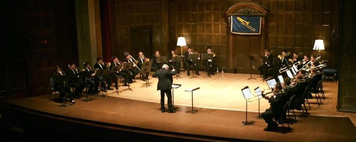 Trombone Choir onstage with conductor in Kilbourn Hall